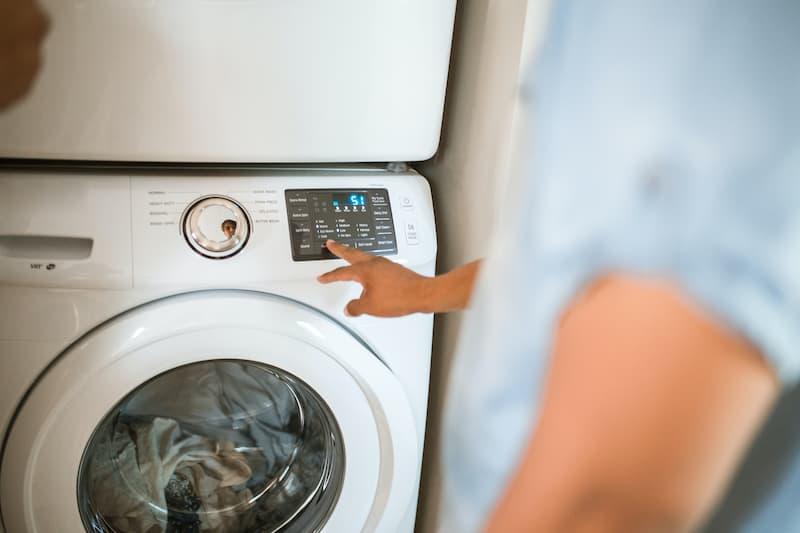 A man using a washing machine.