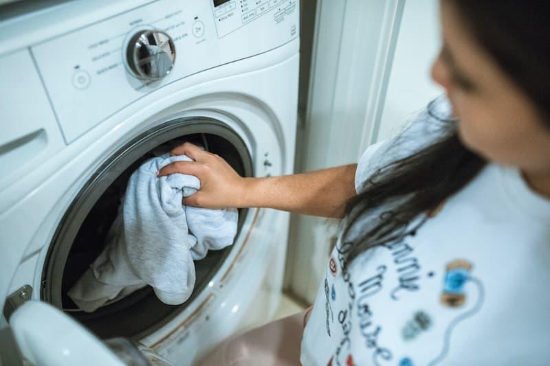  woman stacking the tumble dryer.